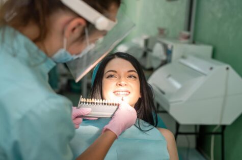 dentist-comparing-patient-s-tooth-with-color-sampler-dentistry (1)