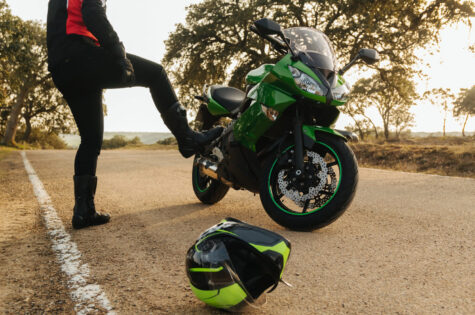 front-view-confused-angry-motorcyclist-with-his-broken-down-motorcycle-road-his-helmet-lying-asphalt-waiting-assistance-mechanic