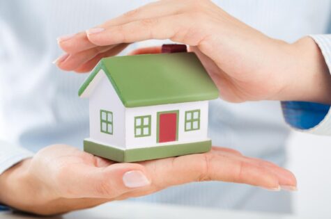 woman-holding-house-model-real-estate-concept